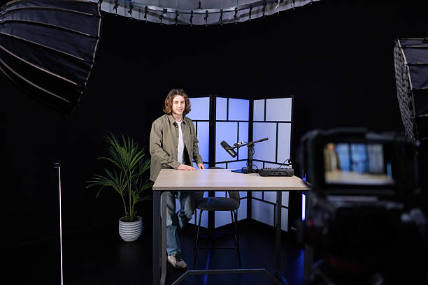 istock Young man recording a podcast in a professional studio 2207520491