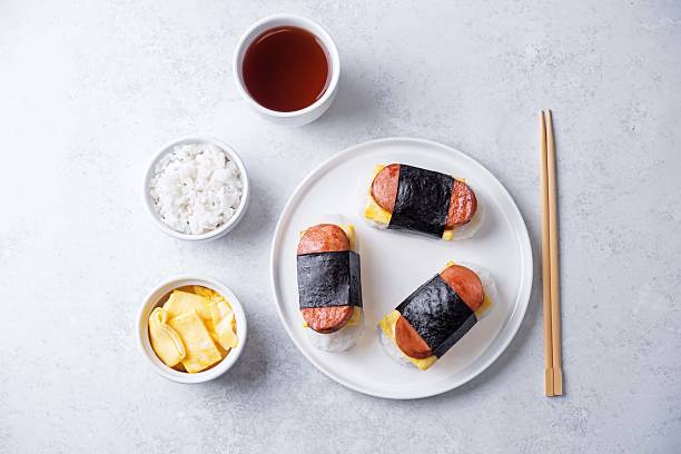 istock Sausage omelette sushi Musubi in a plate on a white background 2207521367