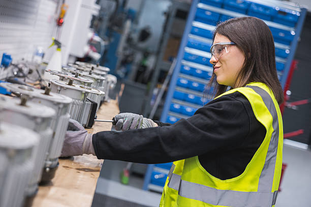 istock Young woman working on a production line using a screwdriver. 2207522041