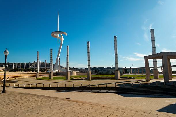 Barcelona, Spain - January 18, 2025: Famous Olympic Park Anella with Telefonica White Communication Tower, Montjuic Hill Landscape, Blue Sky Background