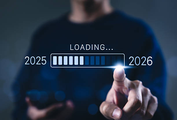 istock Progress and transition from 2025 to 2026 concept. A person pointing to loading bar transitioning from 2025 to 2026, progress, future planning, and new year goals. annual planning and business growth. 2207534770