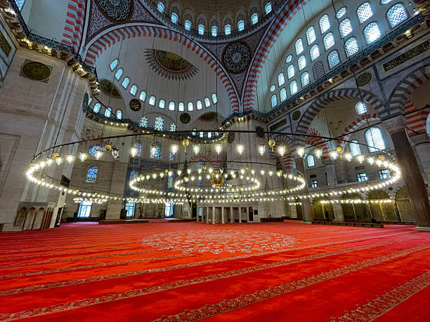 istock Prayer hall interior angle with hanging lanterns, golden accents and patterned dome ceiling 2207538136
