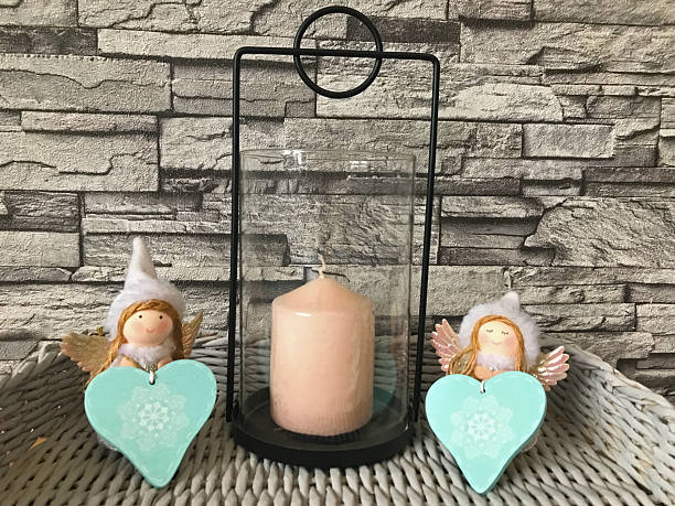 istock Rustic candle arrangement with heart ornaments displayed on weathered stone wall shelf 2207538548