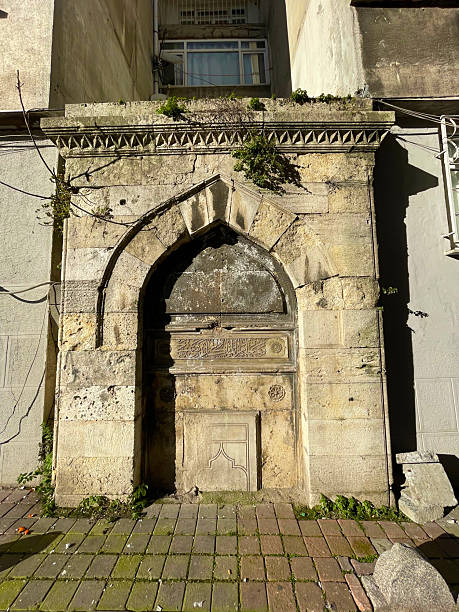 istock Intricately carved stone archway viewed from an angle with framed windows 2207539492