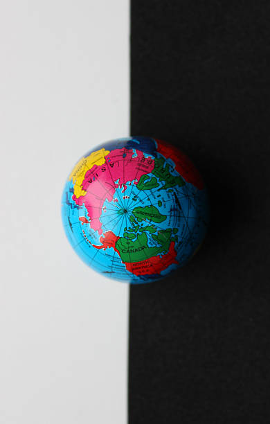 istock The globe lies on the border between the white and black background 2207540232