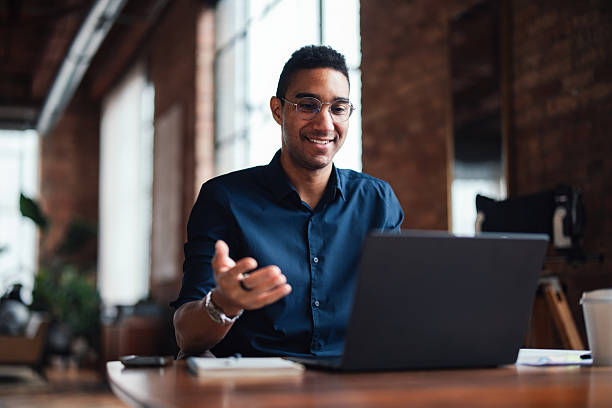 istock Smiling Professional Engaged in Video Call at Office Desk 2207541582
