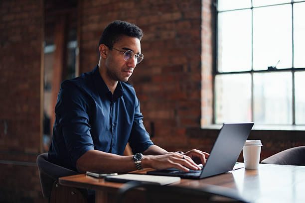 istock Focused Professional Working on a Laptop in a Modern Office Setting 2207541585