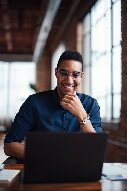 istock Confident Professional Working on Laptop in a Modern Office Setting 2207541590