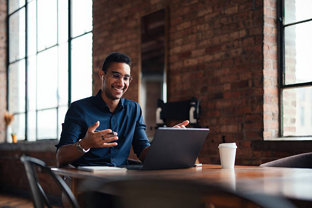istock Young Professional Engaging in Video Call at Loft Office Setting 2207541597