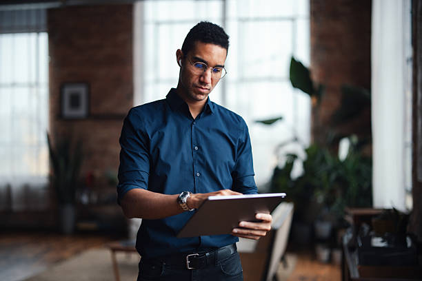 istock Focused Professional Working on Tablet in Modern Home Office Environment 2207541611