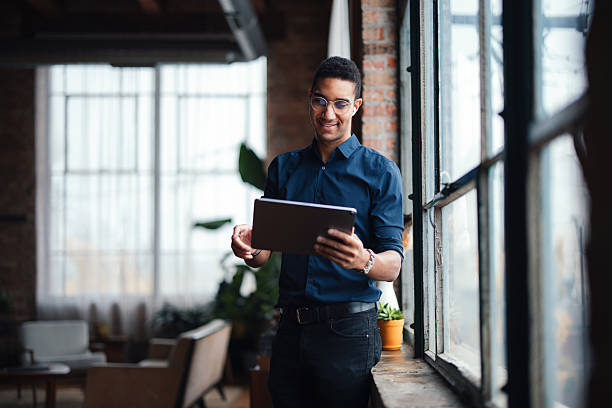 istock Professional Man with Tablet in Modern Workspace with Natural Lighting 2207541612