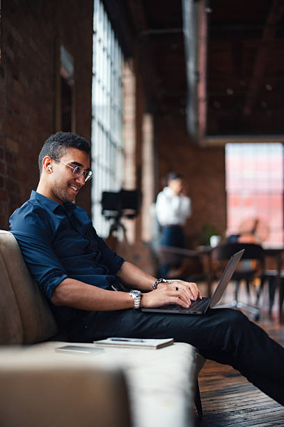 istock Young Professional Working on Laptop in Modern Office Environment 2207541616