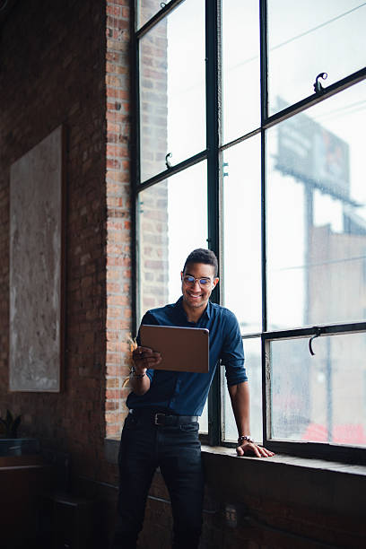 istock Professional Man Working on a Tablet in a Stylish Industrial Office Setting 2207541619