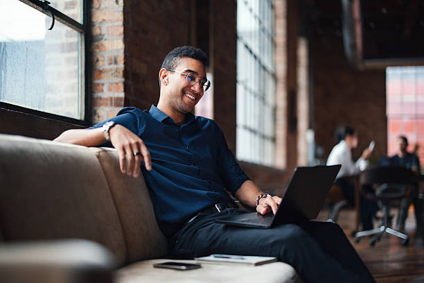 istock Young Professional Working on Laptop in a Modern Cofilled Office Space 2207541620