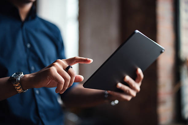 Person Interacting With Digital Tablet in Professional Office Setting