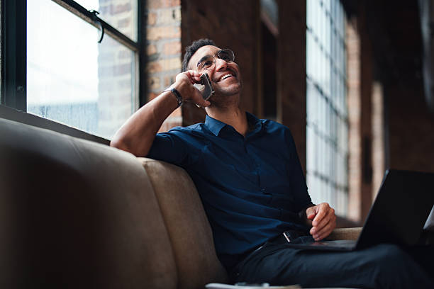 istock Professional in Modern Office Smiling While Engaged in a Phone Call 2207541629