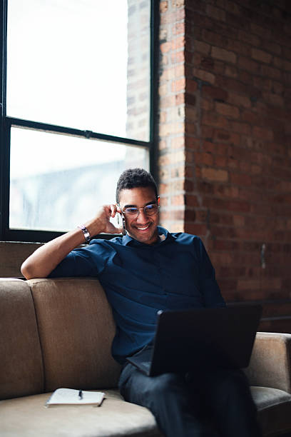 istock Business Professional Smiling While Working on Laptop in Modern Office Setting 2207541640