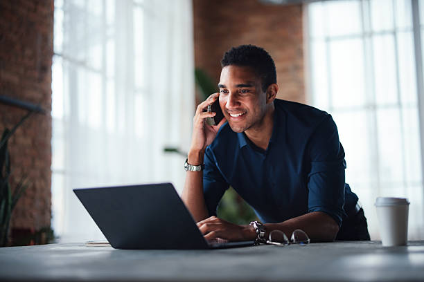 istock Professional Man in Modern Office Using Laptop and Smartphone 2207541648