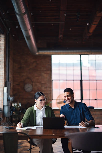 istock Colleagues Collaborating in a Modern Office with Warm Industrial Decor 2207541659