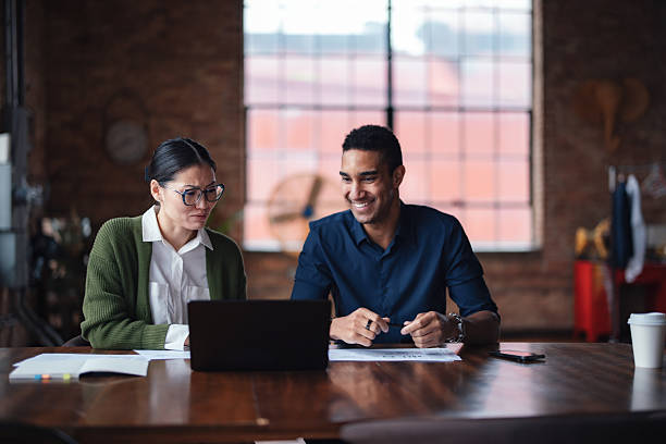 istock Two Professionals Collaborating in a Modern Industrial Style Workspace 2207541662