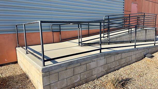 istock concrete exit ramp outside modern warehouse wide loading area minimal design metal railings overhead lights clean lines industrial structure functional space sleek geometry smooth surface 2207550192