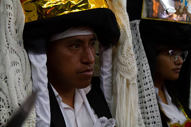 Alangasi, Quito, Pichincha, Ecuador - April 15, 2022: Close-up of indigenous people in traditional costumes participating in the vibrant Diablos de Alangasi procession during Holy Week in Quito, Ecuador, celebrating rich cultural heritage