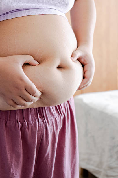 istock Realistic Plus-Size Woman Reflecting on Body Image in Home Setting. 2207553534