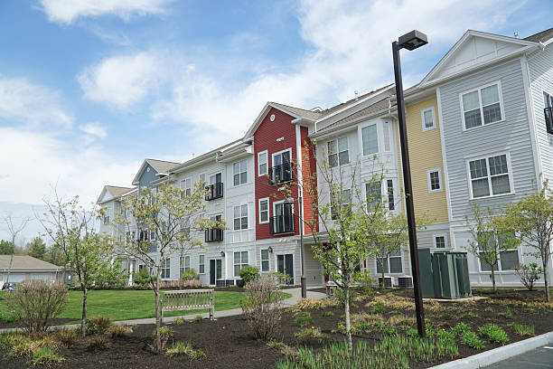 istock colorful apartment buildings and green front lawn in spring 2207554317