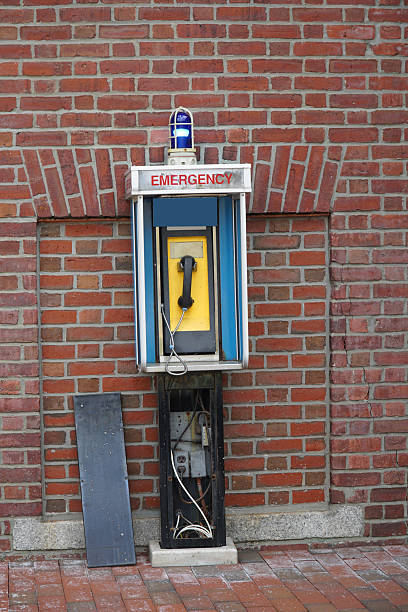 istock old abandoned exterior emergency telephone in front of brick wall 2207554369