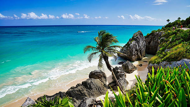 Tulum,Mexico,October 24,2024-Stunning tropical paradise views of blue green sea scape and views of the turquoise blue green waters of the Caribbean Sea with a sandy beach at the late 13th century Mayan ruins of Tulum,Mexico