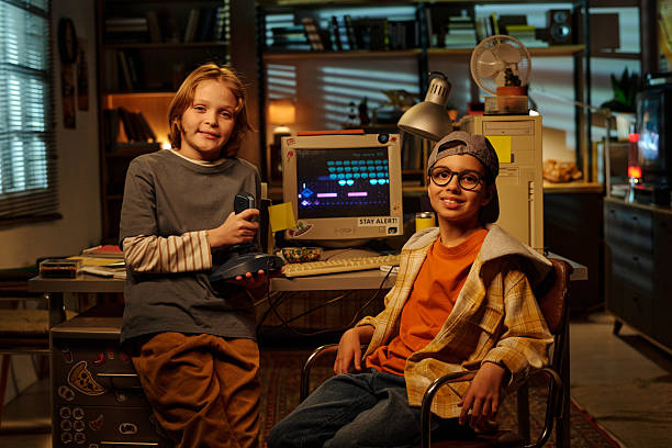 istock Smiling Children Holding Retro Video Game Controllers 2207563621