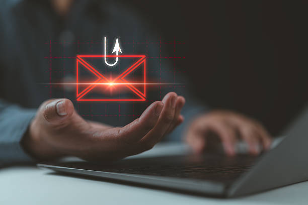 istock Smishing attack, sms spam phishing from scammer, concept. Red envelope with hook icon in criminal hacker hand who use mobile smart phone cyberattack sending scam malware spreading virus text message. 2207563860