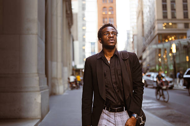 istock City Ambition: Young Man Walking Downtown at Dusk 2207564650