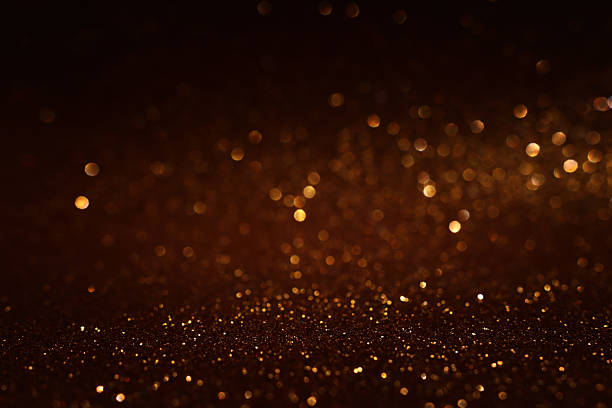 istock background of abstract glitter lights. gold and black. de focused 2207565081