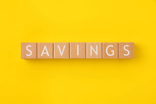 istock Block Words with Savings on a Yellow Background 2207570402
