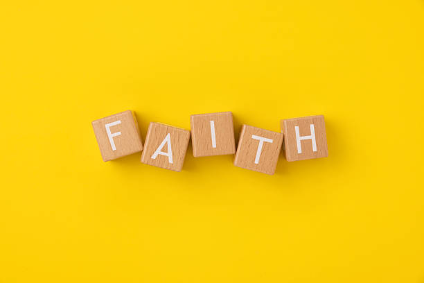 istock Block Words with Faith on a Yellow Background 2207570405