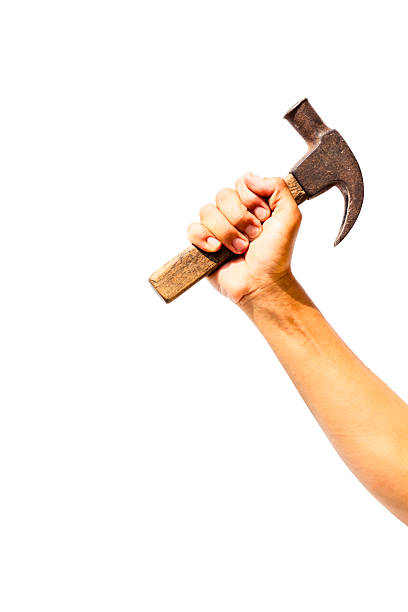 Hand holding hammer and nail isolated on white background. clipping path