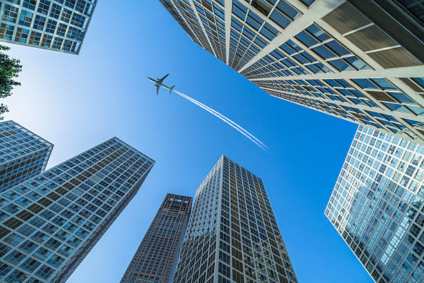 istock Plane flying over the skyscrapers. 2207572283