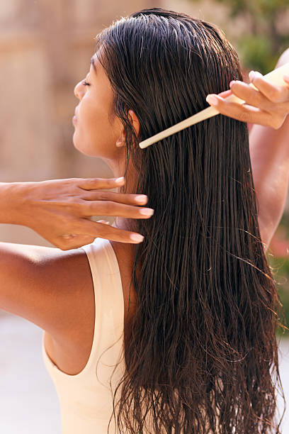 istock Woman Long Hair. Female Practicing Care Routine With Comb and Gentle Touch 2207575571
