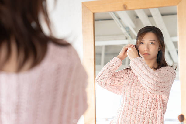 istock asian woman to see a mirror 2207575760