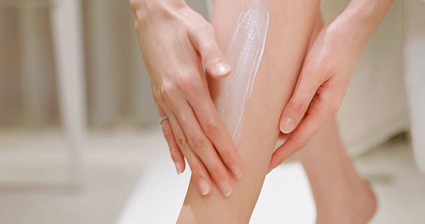 istock asian female lotion calf bathroom 2207576125
