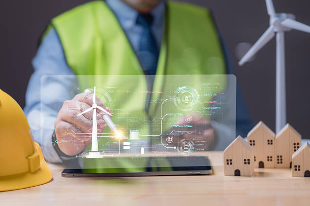 istock Innovating Sustainable Energy Solutions, Professional explores digital energy management using transparent tablet display to enhance wind energy and sustainable housing development 2207577489