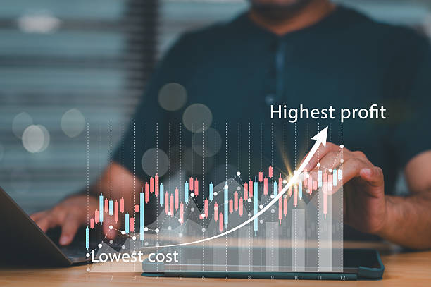 istock A man is pointing at a graph that shows the highest profit. The graph also shows the lowest cost 2207577570