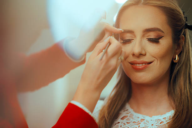 istock Professional Makeup Artist Apply False Eyelashes One by One 2207579941