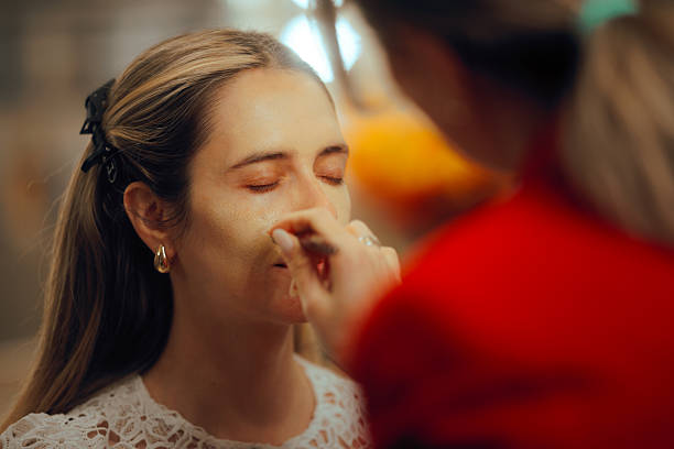 istock Professional Makeup Artist Applying Foundation to a Client with a Brush 2207579943