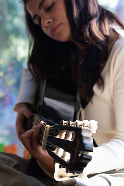 istock close frame of a woman practicing acoustic guitar 2207581552