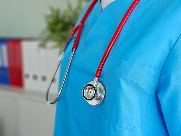 istock Medical professional wearing blue scrubs with stethoscope 2207581726