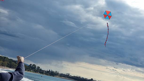 istock spring kite kites flying on the sky rope hand playing 2207582214