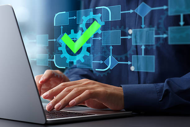 istock Business process automation BPA and management BPM. Flowchart and gear icons with checkmark. Businessman using laptop computer to manage workflow automation system. 2207584633