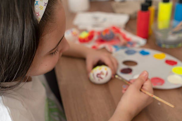 istock Little girl painting easter egg 2207587452
